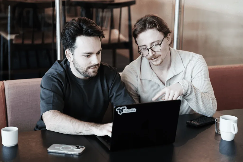 Two TokenTek engineers working together at a laptop